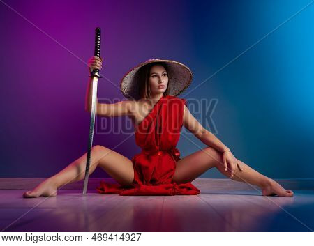 Sexy Woman In A Red Cape And An Asian Hat With A Katana In Her Hand Image Of A Samurai In Neon Color