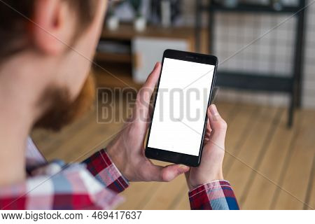 Mock Up, Copyspace, Template And Technology Concept. Man Looking At Black Vertical Smartphone With W