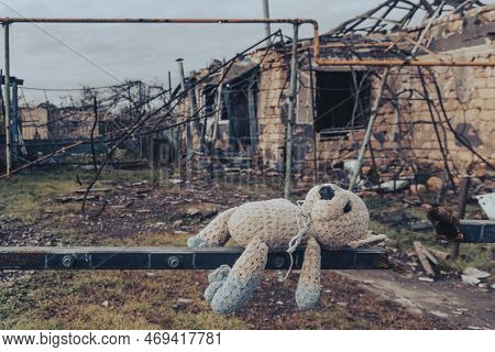 Countryside. Toy (teddy Bear) Against The Backdrop Of A House Destroyed By Shelling. War In Ukraine.