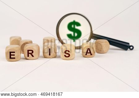 Business Concept. On A White Surface, A Magnifying Glass With A Dollar Symbol And Cubes With The Ins