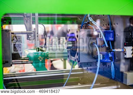 Automatic Injection Molding Machine Making Disposable Plastic Cup At Exhibition, Trade Show. Manufac