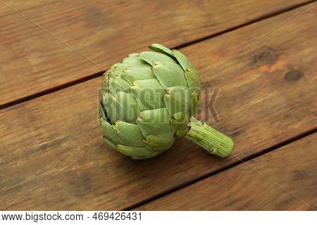 Fresh Raw Green Artichoke On Wooden Table