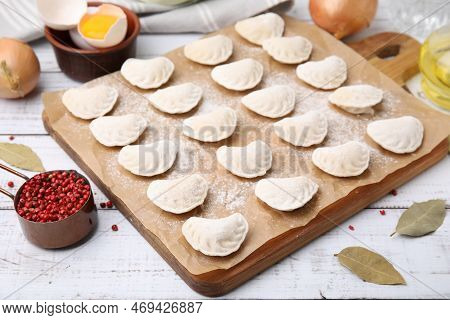 Raw Dumplings (varenyky) With Tasty Filling And Ingredients On White Wooden Table