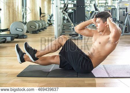 Sporty Couple Working Out Together In The Gym. Couple Doing Acro Yoga At Gym.