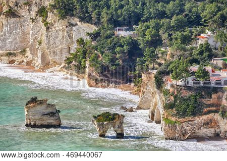 Picturesque Islets Faraglioni Di Puglia In Summer Adriatic Sea Bay Baia Delle Zagare. Mattinata Fara