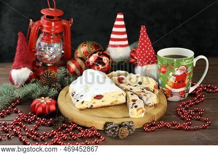 Traditional Stollen With Decoration And Cup Of Coffee On Wooden Background