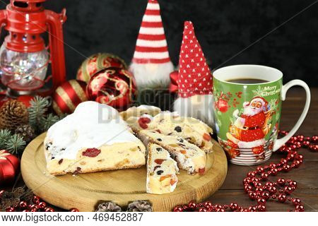 Traditional Stollen With Decoration And Cup Of Coffee On Wooden Background