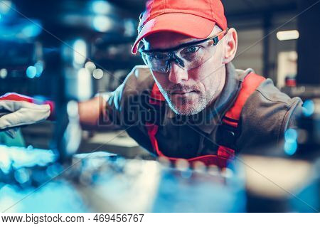 Caucasian Milling Or Lathe Machine Operator In His 40s Wearing Safety Glasses. Metalworking Industry