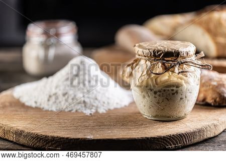 Rye Sourdough Ripened In A Jar Together With Flour On A Cutting Board