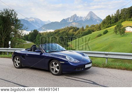 Berchtesgaden, Germany - July 25, 2021: Blue Roadster Porsche Boxster 986 With Mountain Watzmann And