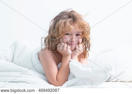 Funny Kid In Bed With Comfortable Mattress Soft Pillow White Bedding. Kid Wake Up Cover Blanket. Goo