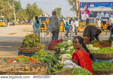 Puttaparthi, Andra Pradesh - India - January 21.2023: A Women Selling Vegetables On The Local Indian