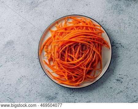 Carrot Noodles On Plate Overhead. Vegetable Noodles - Orange Sweet Carrot Spaghetti On Plate Over Gr