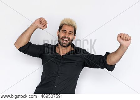 Portrait Of Successful Young Man Makig Winning Gesture Over White Background. Caucasian Guy With Stu