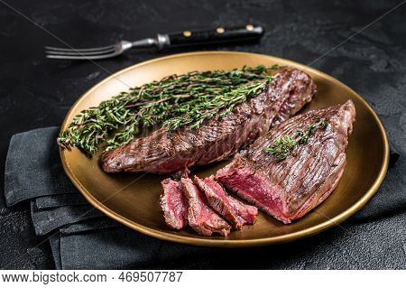 Bbq Grilled Bavette Bavet Beef Meat Steak With Herbs On A Plate. Black Background. Top View