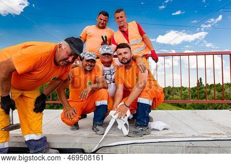 Zrenjanin, Vojvodina, Serbia - June 08, 2021: Construction Smiling Workers Are Posing, Resting And E