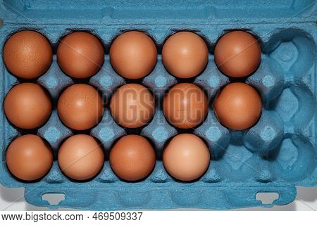 Top View Freerange Fresh Eggs In Blue Recycled Carton Crate. Farm Texture Soft Light Closeup