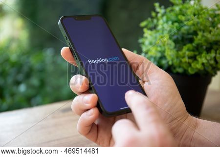 Alanya, Turkey - February 23, 2022: Man Hand Holding Iphone 13 With Application Booking.com Online H