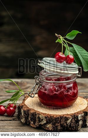 Jar Of Cherry Jam And Sour Cherries. Berries Cherry With Syrup. Ripe Ripe Cherries. Sweet Red Cherri