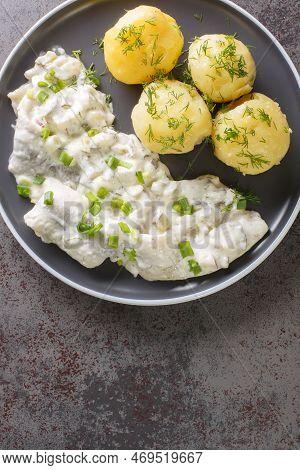 German Food Sahnehering Herring Fillet In Creamy Sauce With Boiled Potato Garnish Close-up In A Plat