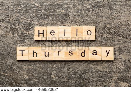 Hello Thursday Word Written On Wood Block. Hello Thursday Text On Cement Table For Your Desing, Conc