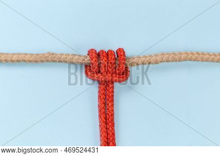 Rope Prusik Knot Tied With An Accessory Cord On The Main Rope On A Blue Background