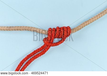 Rope Klemheist Knot Tied With An Accessory Cord On The Main Rope On A Blue Background