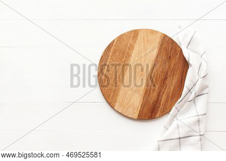 Empty Round Wooden Cutting Board With Kitchen Towel On White Table. Round Cutting Board Or Serving T