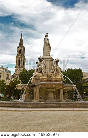 A View Of A Decorative Fountain In The Square At Fontaine Pradier In The French City Of Nimes.