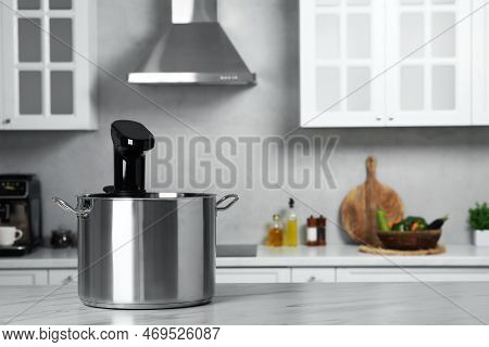 Pot With Sous Vide Cooker On Table In Kitchen, Space For Text. Thermal Immersion Circulator