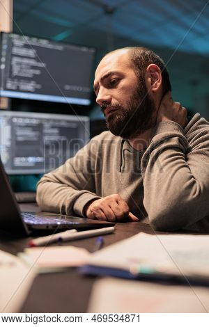 Tired App Developer Dealing With Back Pain And Pressure, Working Late At Night And Feeling Tense. Ex
