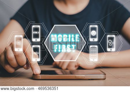 Mobile First Concept, Person Hand Using Smart Phone With Mobile First Icon On Virtual Screen, Digita