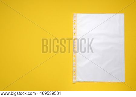 Punched Pocket With Paper Sheet On Yellow Background, Top View. Space For Text
