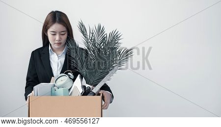 A Woman Office Worker Is Unhappy With Being Fired From A Company Packing Things Into Cardboard Boxes