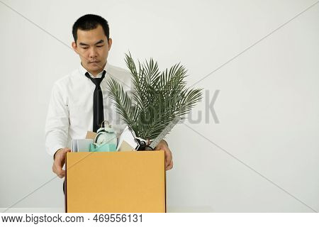 A Male Office Worker Is Unhappy With Being Fired From A Company Packing Things Into Cardboard Boxes.