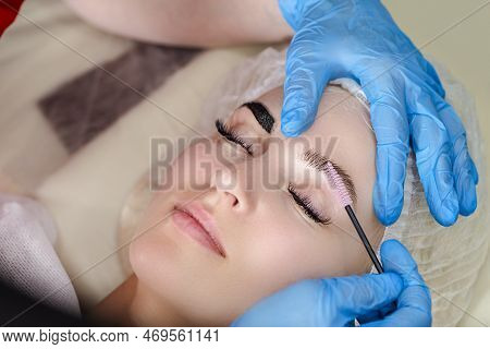 Beautician Tattooing Woman's Eyebrows Using Special Equipment During Process Of Permanent Make-up Ti