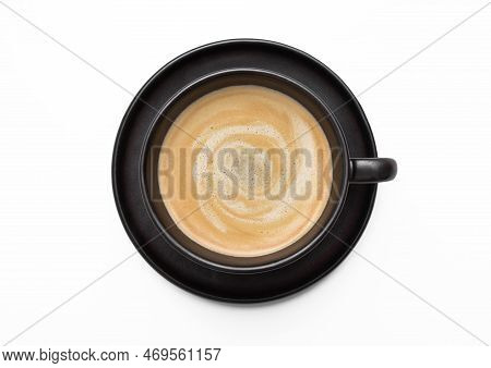 Large Black Creamy Coffee In Porcelain Cup With Saucer On White. Top View.