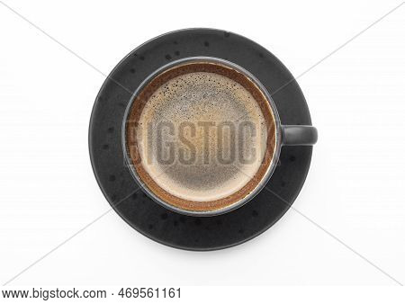 Large Black Coffee In Porcelain Cup With Saucer On White. Top View.