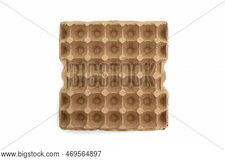 A Large Cardboard Container For Eggs Lies On A White Background.