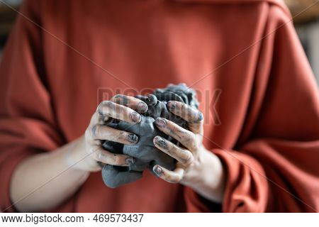 Woman Holding Piece Of Clay While Visiting Pottery Master Class, Learning How To Make Ceramics. Crop
