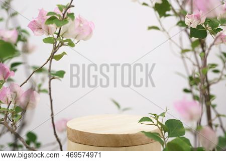 Empty Wooden Podium Blurred Pink  Flowers Decoration On White Background With Space.beauty Cosmetic 