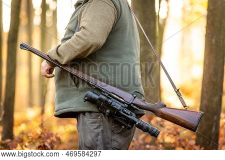 Hunter Or Ranger With A Professional, Nightvision Hunting Gun And Hunting Form To Hunt In An Autumn 