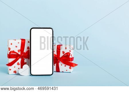 Mobile Phone With Blank Screen On Colored Background With Hearts, Calendar And Gift Box, Valentine D