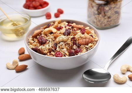 Tasty Granola Served With Nuts And Dry Fruits On White Marble Table