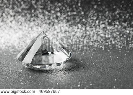 Beautiful Dazzling Diamond On Shiny Glitter Background, Space For Text. Precious Gemstone