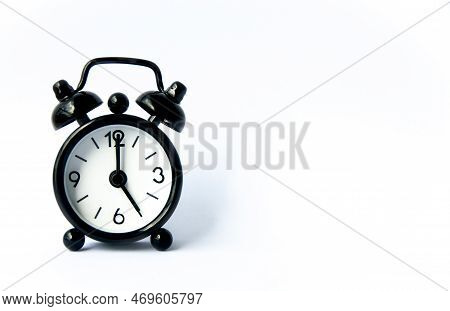 Black Alarm Clock Pointing At 5 Oclock With Customizable Space For Text On White Background. Copy Sp
