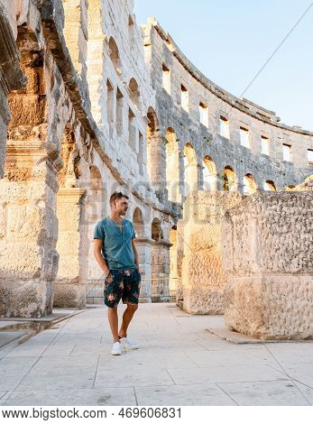 Young Men Tourist Visit Pula City In Croatia, Roman Amphi Theatre Arena In Pula