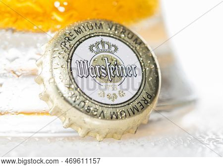 London, Uk - December 12, 2022: Warsteiner Lager Beer Bottle Cap With Dew And Cold Glass On White.