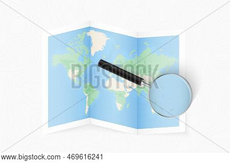 Enlarge Kiribati With A Magnifying Glass On A Folded Map Of The World. Vector Paper Map.