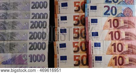 Czech And Euro Banknotes Stacked On Top Of Each Other, Photo